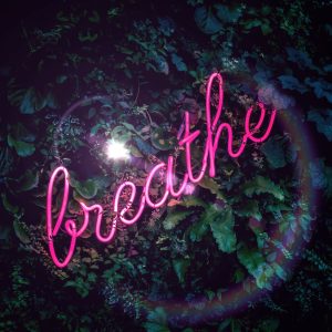 neon sign that says breathe
